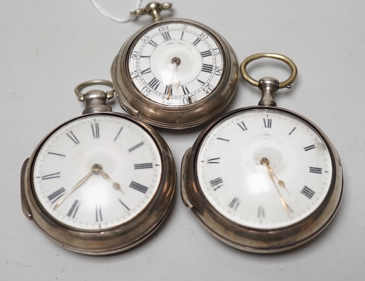 An 18th century silver pair cased keywind verge pocket watch, by Sam Toulmin, London, a similar watch by Tomlin, London and one other silver pair cased pocket watch with unsigned movement.